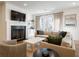 Inviting living room featuring a fireplace, large sectional sofa, and access to an outdoor area at 803 Courtenay Ne Dr, Atlanta, GA 30306