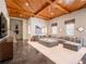 Inviting living room with wood-paneled ceiling, large sectional sofa, and expansive rug, perfect for relaxation and entertainment at 803 Courtenay Ne Dr, Atlanta, GA 30306
