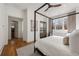 View of main bedroom suite featuring a four-poster bed, hardwood floors, and a walk-in closet at 803 Courtenay Ne Dr, Atlanta, GA 30306