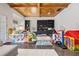 Bright playroom with a wood-paneled ceiling, built-in shelving, and ample space for play and activities at 803 Courtenay Ne Dr, Atlanta, GA 30306