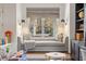 Cozy window seat with decorative pillows and soft lighting, nestled between bookshelves and a built-in desk at 803 Courtenay Ne Dr, Atlanta, GA 30306
