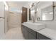 Modern bathroom featuring gray vanity, double mirrors, and a glass-enclosed shower at 180 Railroad St, Canton, GA 30114