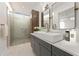 Modern bathroom featuring gray vanity, double mirrors, and a glass-enclosed shower at 180 Railroad St, Canton, GA 30114