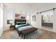 Stylish bedroom featuring a decorative rug, ensuite bathroom, and bright natural light at 180 Railroad St, Canton, GA 30114