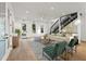 Bright living room featuring hardwood floors, a modern staircase, and large windows at 180 Railroad St, Canton, GA 30114
