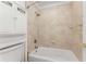 Bright bathroom featuring a tiled shower and tub combination with a neutral color palette at 3186 Sugarplum Ne Rd, Atlanta, GA 30345