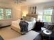 Cozy bedroom features neutral decor, two windows providing natural light, and ceiling fan at 3186 Sugarplum Ne Rd, Atlanta, GA 30345