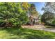 Beautiful home exterior with lush green lawn and large shade trees on a sunny day at 3186 Sugarplum Ne Rd, Atlanta, GA 30345