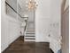 Bright foyer with chandelier, stairs and drop-down desk adds a luxury touch at 3186 Sugarplum Ne Rd, Atlanta, GA 30345