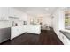 Open concept kitchen features white cabinets, stainless appliances, and adjacent dining area at 3186 Sugarplum Ne Rd, Atlanta, GA 30345