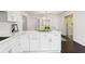 Bright, white kitchen features a breakfast bar with quartz countertops and stainless steel appliances at 3186 Sugarplum Ne Rd, Atlanta, GA 30345