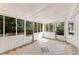Bright sunroom with tiled flooring and large windows offering backyard views at 3186 Sugarplum Ne Rd, Atlanta, GA 30345