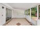 Enclosed sunroom featuring tiled floors and multiple windows for natural light and view at 3186 Sugarplum Ne Rd, Atlanta, GA 30345
