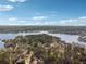 Scenic aerial view showcases a beautiful lake, lush trees, and stunning blue sky at 404 Willow Way, Villa Rica, GA 30180