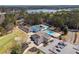 Aerial view of community pool, tennis courts, golf course, community center, and lake at 404 Willow Way, Villa Rica, GA 30180