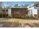 Exterior view of a home with a large screened deck overlooking the backyard at 404 Willow Way, Villa Rica, GA 30180