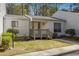 Attractive townhome featuring a quaint porch, grassy yard, and lovely landscaping at 404 Willow Way, Villa Rica, GA 30180