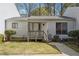 Charming single-story townhome featuring a wooden porch and well-maintained front lawn at 404 Willow Way, Villa Rica, GA 30180