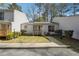 Inviting townhome exterior with a cozy porch, manicured lawn, and convenient sidewalk access at 404 Willow Way, Villa Rica, GA 30180