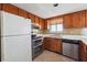 Functional kitchen featuring wooden cabinets, stainless steel appliances, and tile flooring at 404 Willow Way, Villa Rica, GA 30180