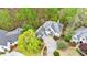 Aerial view of a large house surrounded by lush trees, landscaping, and a driveway at 460 Laurel Chase Ct, Atlanta, GA 30327