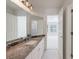 Bathroom with double vanity, granite countertop, white cabinets, and tiled floor at 460 Laurel Chase Ct, Atlanta, GA 30327