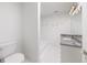 White tiled bathroom with toilet, tub, and shower at 460 Laurel Chase Ct, Atlanta, GA 30327