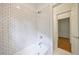 Bathroom with white subway tile, white bathtub, and a door leading to another area of the home at 460 Laurel Chase Ct, Atlanta, GA 30327