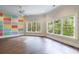 Spacious bedroom with colorful accent wall and large windows offering natural light and a view of the surrounding trees at 460 Laurel Chase Ct, Atlanta, GA 30327