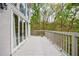 Spacious deck features white painted wood and overlooks wooded backyard at 460 Laurel Chase Ct, Atlanta, GA 30327
