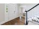 Welcoming entryway featuring hardwood floors, a front door with sidelights, and staircase with black railing at 460 Laurel Chase Ct, Atlanta, GA 30327