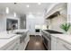 Beautiful kitchen featuring a stainless steel range, white cabinetry, and a center island sink at 460 Laurel Chase Ct, Atlanta, GA 30327