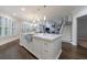 Bright open kitchen boasts a large center island, stainless steel sink, and pendant lighting at 460 Laurel Chase Ct, Atlanta, GA 30327