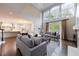 Bright and spacious living room with high ceilings, modern sofas, hardwood floors, and backyard views at 460 Laurel Chase Ct, Atlanta, GA 30327