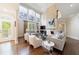 Spacious living room filled with natural light features a stone fireplace and access to the outdoors at 460 Laurel Chase Ct, Atlanta, GA 30327