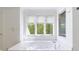 Relaxing main bathroom with soaking tub and a large window overlooking a private wooded area at 460 Laurel Chase Ct, Atlanta, GA 30327