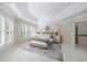 Comfortable main bedroom boasts a decorative tray ceiling, plush carpet, and large bright windows at 460 Laurel Chase Ct, Atlanta, GA 30327