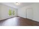 Sun-filled room with hardwood floors, a white door, and a large window with peaceful wooded views at 460 Laurel Chase Ct, Atlanta, GA 30327