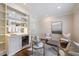 Inviting seating area with a stylish bar area, shelving, and an elegant arrangement of chairs at 460 Laurel Chase Ct, Atlanta, GA 30327