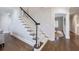 Traditional staircase with hardwood floors and white carpet at 460 Laurel Chase Ct, Atlanta, GA 30327