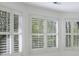 Multiple white-shuttered windows provide ample natural light at 460 Laurel Chase Ct, Atlanta, GA 30327