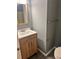 Bathroom featuring a wooden vanity with a solid surface top, a mirror, and updated fixtures at 5331 Ridge Forest Dr, Stone Mountain, GA 30083