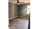 Bright bedroom features laminate wood floors, neutral gray walls, and a ceiling fan at 5331 Ridge Forest Dr, Stone Mountain, GA 30083