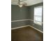 Bedroom with neutral paint, stylish chair rail detail, and a bright window at 5331 Ridge Forest Dr, Stone Mountain, GA 30083