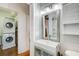 A bathroom vanity is next to a doorway with a stacked washer and dryer at 733 Frederica Ne St # 12, Atlanta, GA 30306