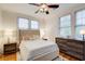 Bright bedroom featuring hardwood floors, a ceiling fan, and large windows with wood blinds at 733 Frederica Ne St # 12, Atlanta, GA 30306