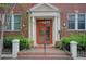 Inviting entryway with classic brick steps leading to a red double door under a decorative white frame at 733 Frederica Ne St # 12, Atlanta, GA 30306