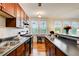 Galley-style kitchen with dark countertops, wood cabinets, modern appliances, and natural light at 733 Frederica Ne St # 12, Atlanta, GA 30306