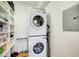 A closet features a stacked, white, front-loading washer and dryer next to storage shelves at 733 Frederica Ne St # 12, Atlanta, GA 30306