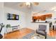 Open-concept living space with hardwood floors, a mounted TV, and seamless flow to the kitchen at 733 Frederica Ne St # 12, Atlanta, GA 30306